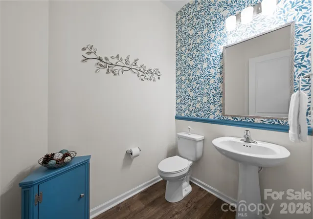 a bathroom with a sink toilet and a mirror