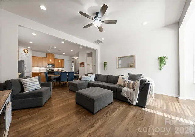 a living room with furniture and a ceiling fan
