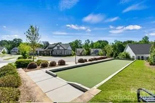 a view of a swimming pool with a lawn chairs and a fire pit