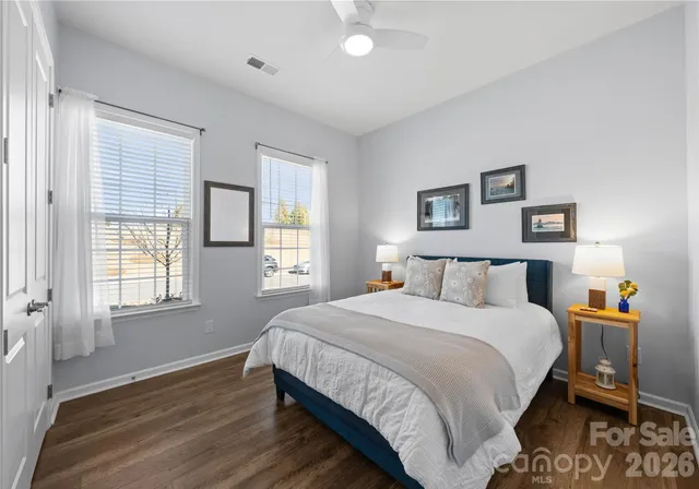 a bedroom with a bed and wooden floor