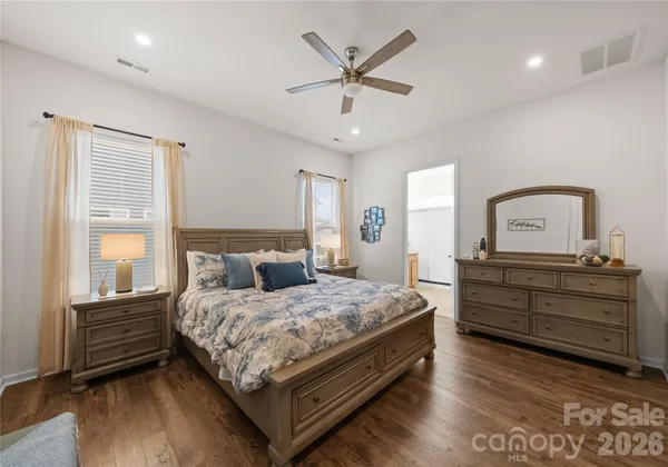 a bedroom with a bed window and a dresser