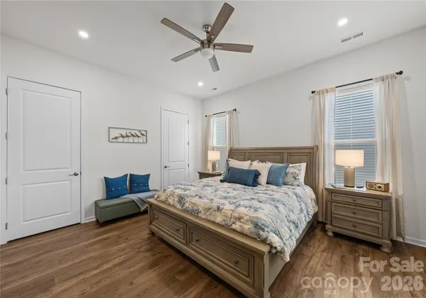 a bedroom with a bed window and a ceiling fan