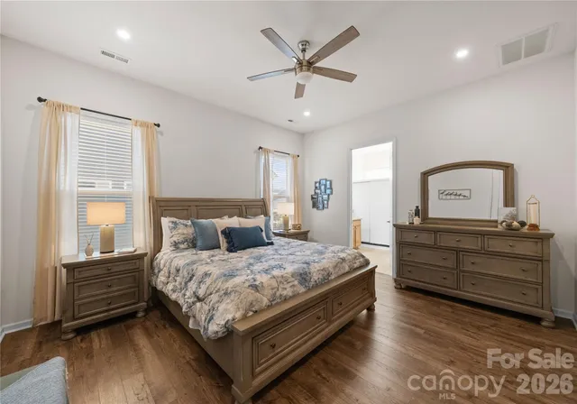 a bedroom with a bed window and a dresser