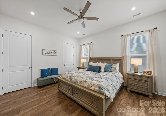 a bedroom with a bed window and a ceiling fan