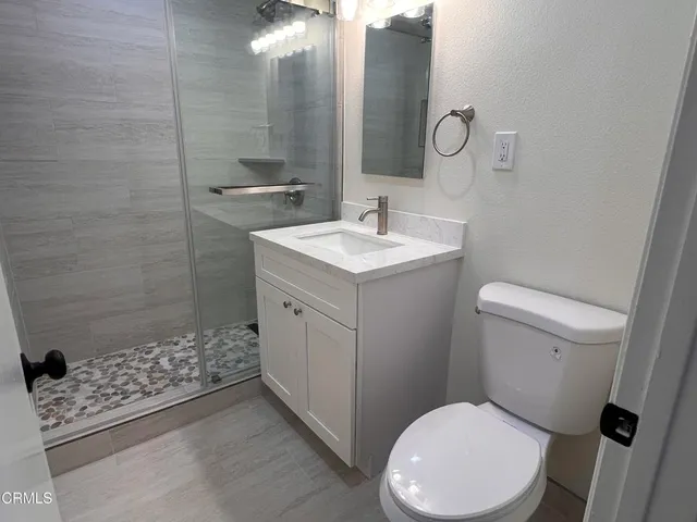 a bathroom with a sink toilet and shower
