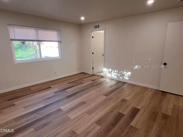 a view of wooden floor and windows in a room