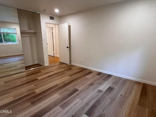 a view of room with wooden floor and window