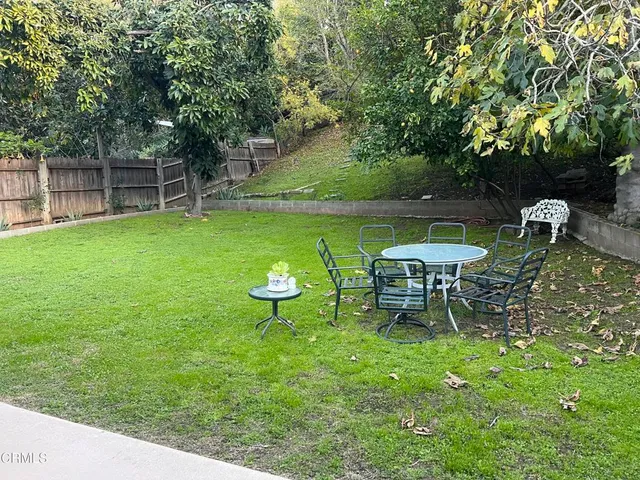 a view of a table and chairs in the garden