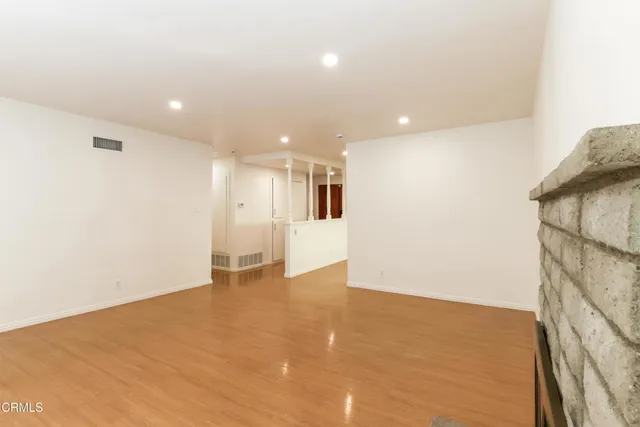 a kitchen with stainless steel appliances granite countertop a stove a refrigerator and a granite counter tops with white cabinets