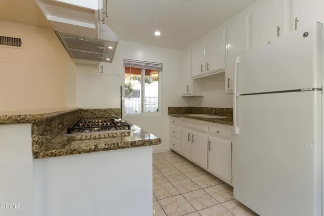 a white toilet sitting next to a bathroom sink and a shower