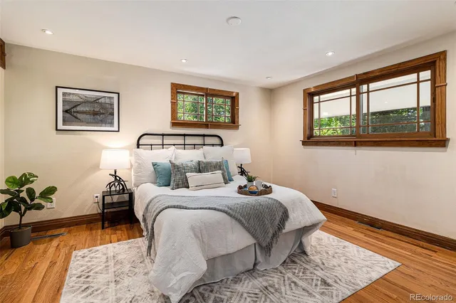 a bedroom with a bed and a painting on the wall