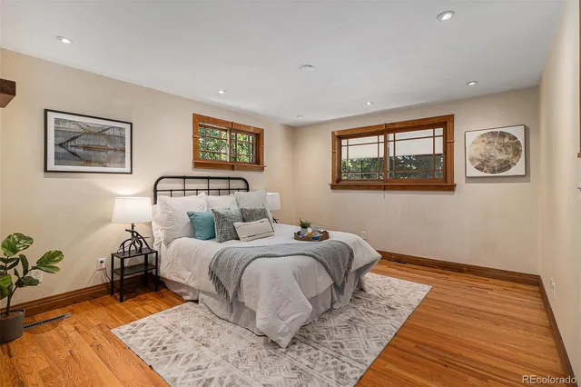 a bedroom with double bed and a wooden floor