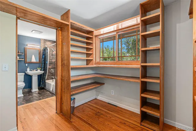 a view of room with wooden floor and windows