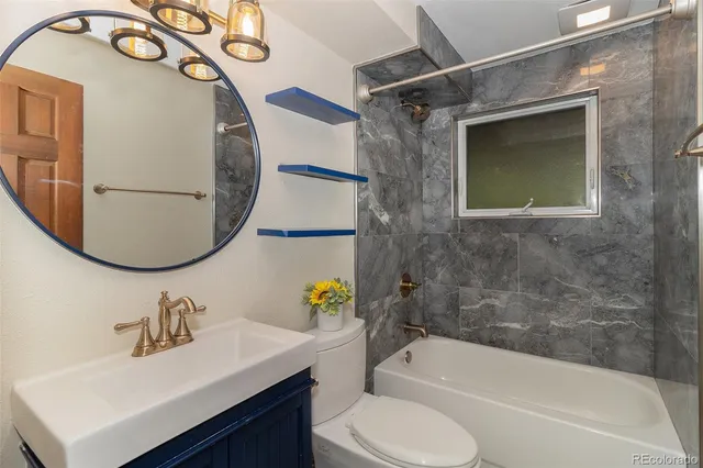 a bathroom with a sink mirror toilet and bathtub