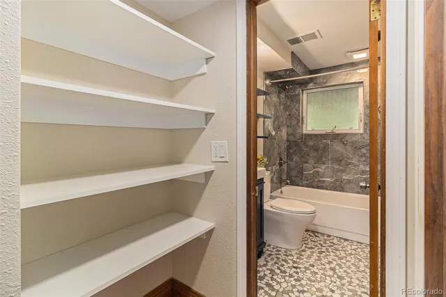 a bathroom with a toilet and a shower