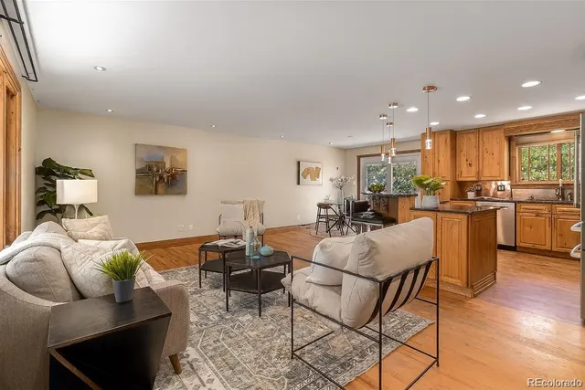 a living room with furniture and kitchen view