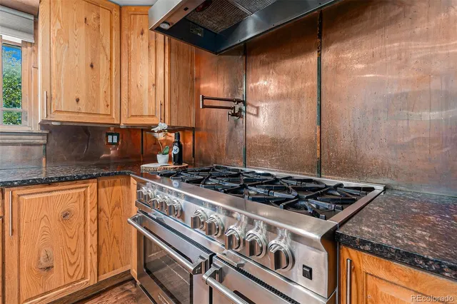 a stove top oven sitting inside of a kitchen