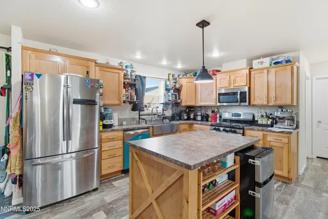 a kitchen with kitchen island a counter top space appliances and cabinets