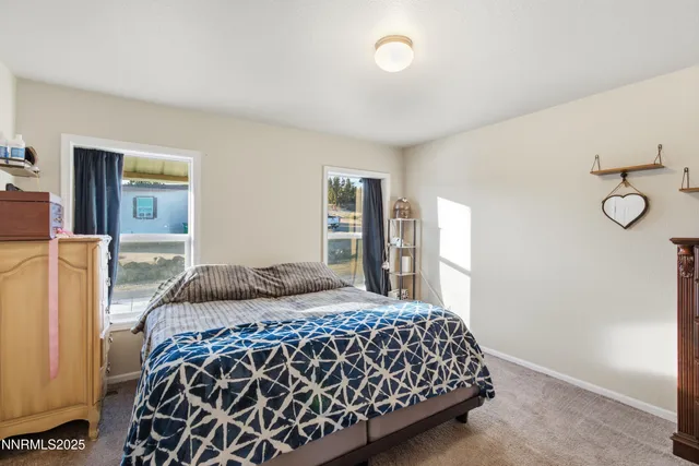 a bedroom with a large bed and a dresser