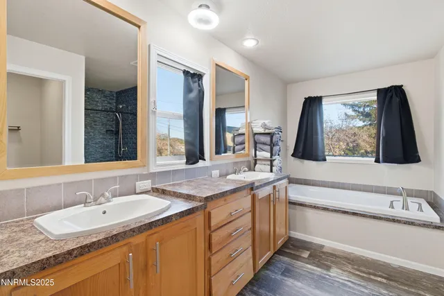 a bathroom with a double vanity sink and a mirror