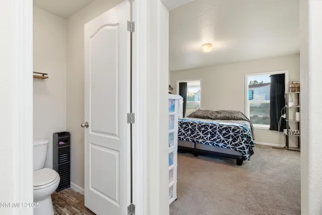 a bedroom with a bed and a view of bathroom