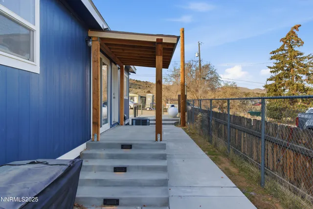 a view of a balcony with wooden floor and seating space