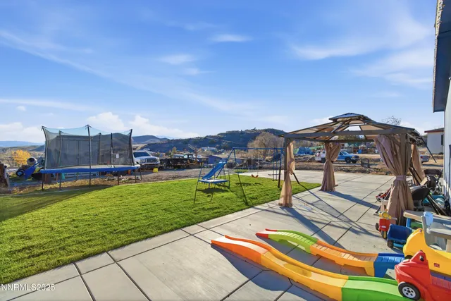 a view of a house with patio and a yard