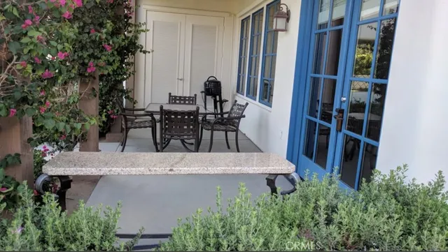 a kitchen with granite countertop stainless steel appliances a sink cabinets and a window