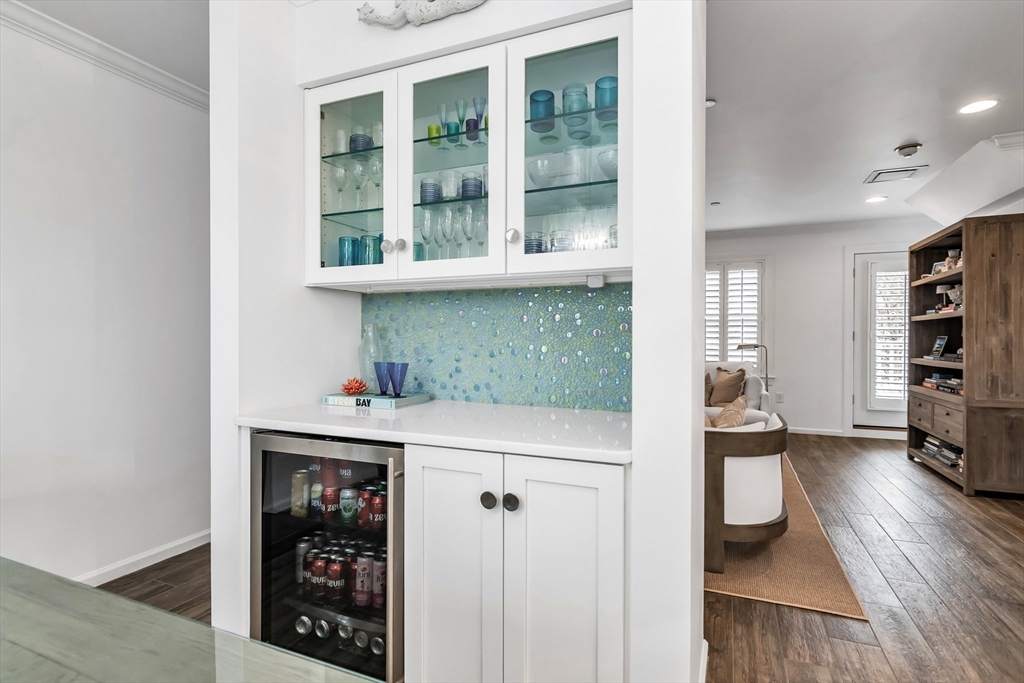 6 Summer Street, Unit D Manchester, MA 01944 - Photo 18 of 31 a kitchen with stainless steel appliances a refrigerator and a wooden floor