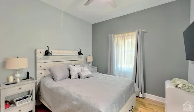 a bedroom with a bed and a window