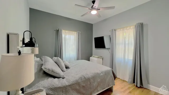 a bedroom with a bed and a flat screen tv