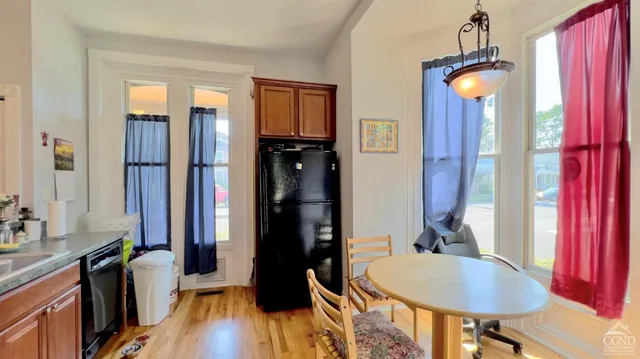 a dining room with furniture and window
