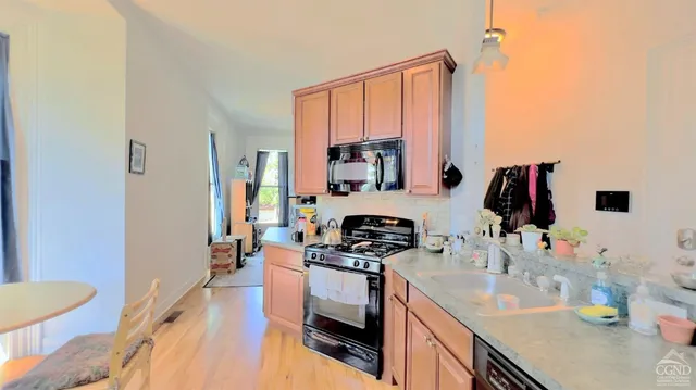 a kitchen with a sink stove and refrigerator