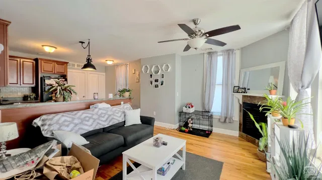 a living room with furniture a fireplace and a chandelier