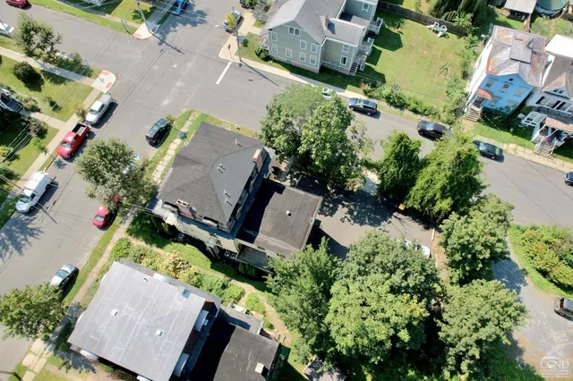 an aerial view of a house with a garden and swimming pool