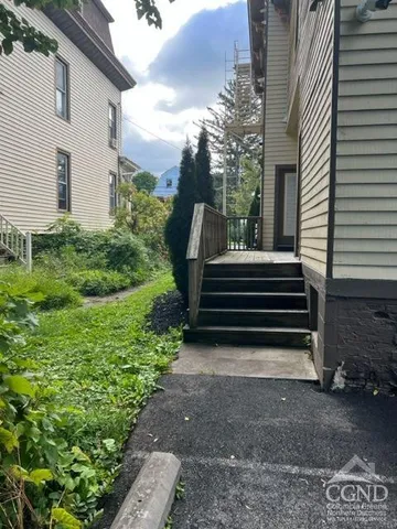 a front view of a house with outdoor seating