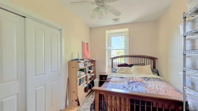 a bedroom with furniture and a window