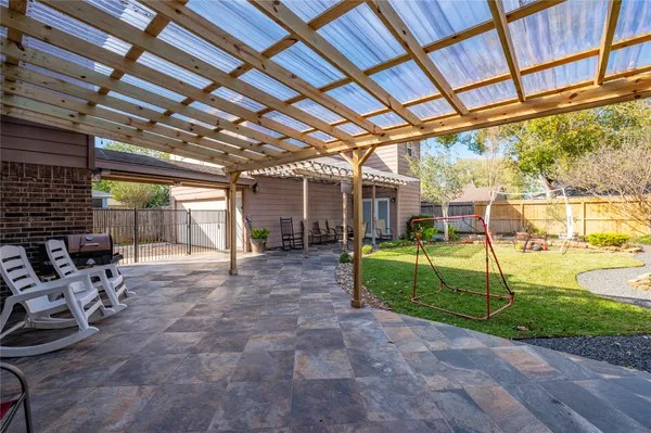 a view of a patio with table and chairs and potted plants