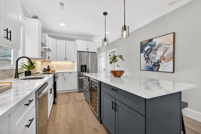 a kitchen with a sink appliances and cabinets
