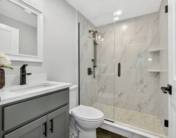 a bathroom with a sink toilet and shower