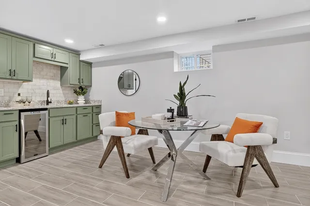 a view of a kitchen area with furniture and wooden floor