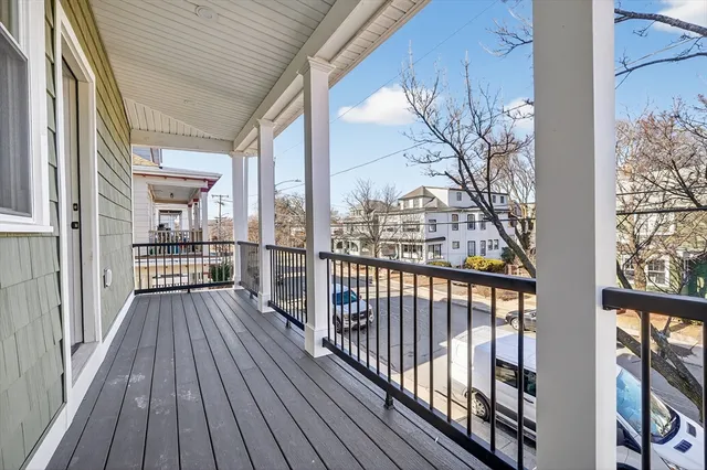 a view of a balcony with wooden floor