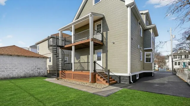 a view of a house with a yard and furniture