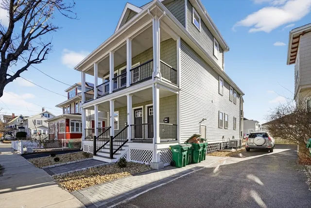 a front view of a building with sitting area