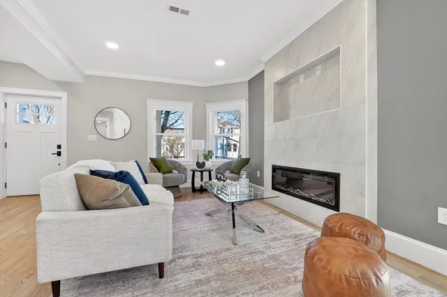 a living room with furniture and a fireplace