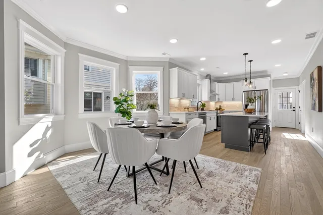 a view of a dining room with furniture window and wooden floor
