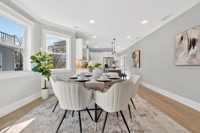 a view of a dining room with furniture and a potted plant