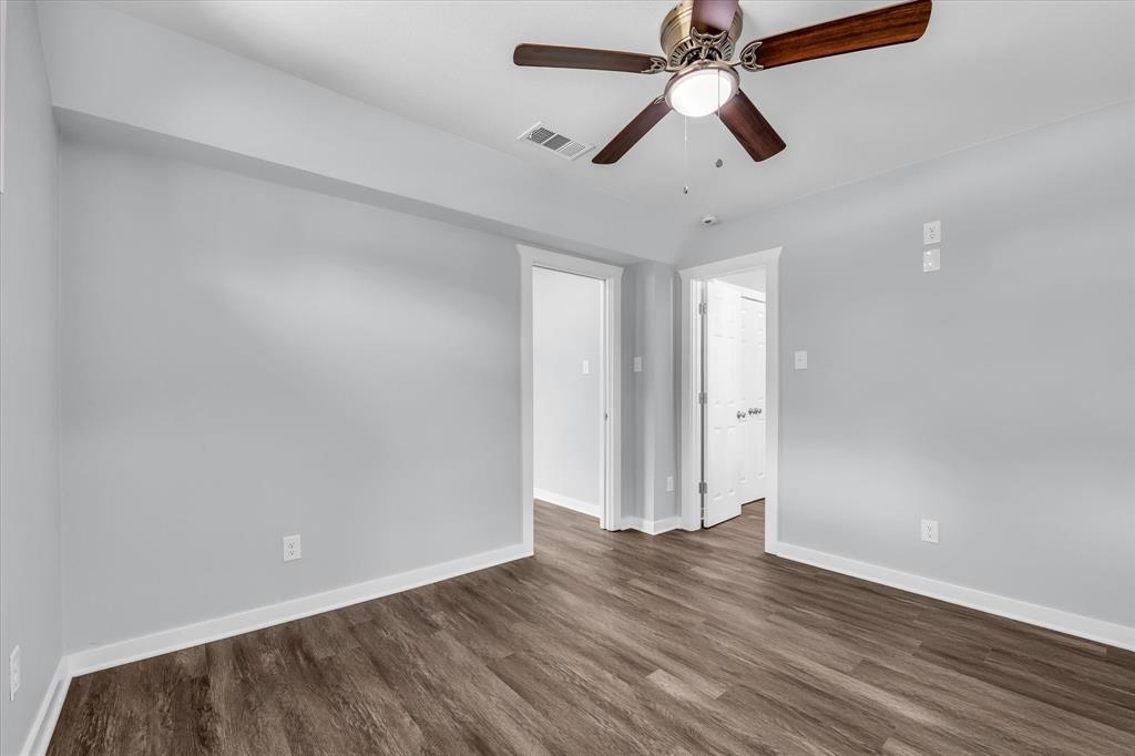 3608 North 26th Street Waco, TX 76708 - Photo 12 of 28 an empty room with wooden floor ceiling fan and windows