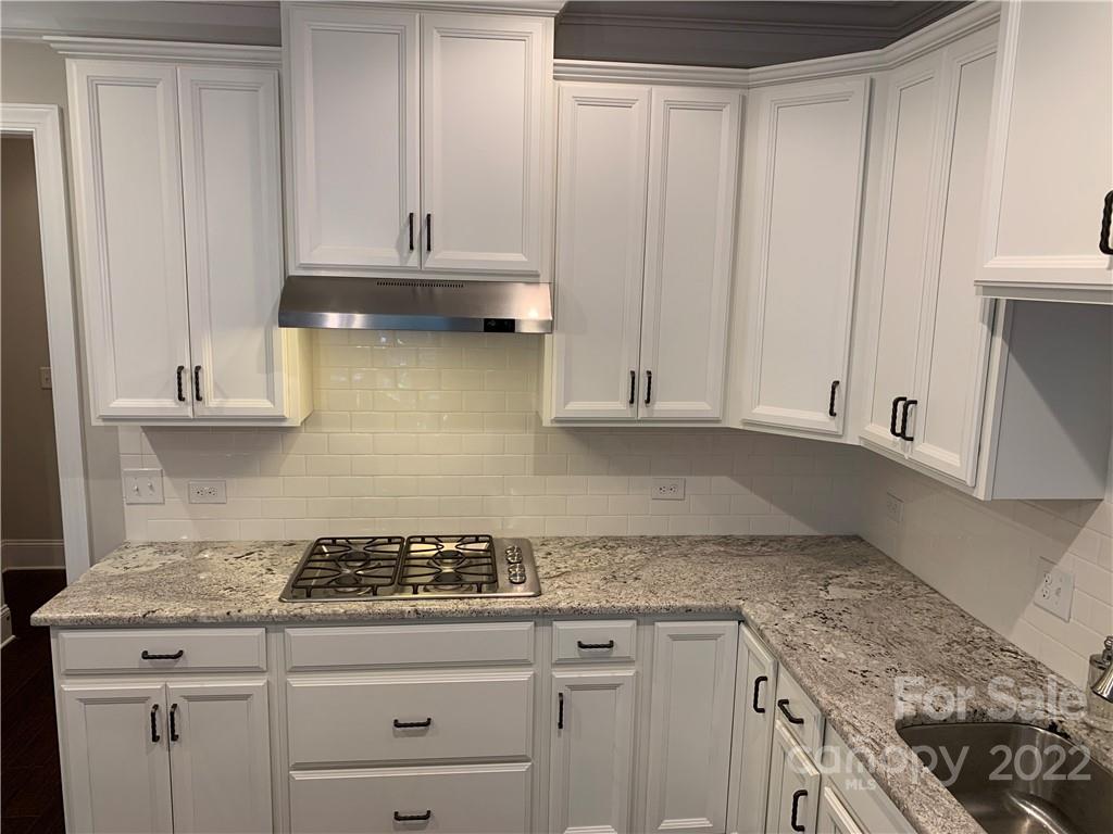 907 Ospre Lane Fort Mill, SC 29708 - Photo 14 of 39 a kitchen with granite countertop a sink a stove and cabinets