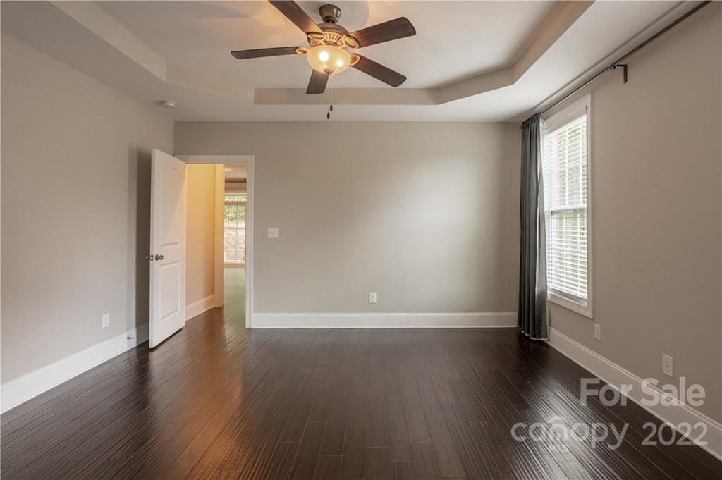 907 Ospre Lane Fort Mill, SC 29708 - Photo 15 of 39 an empty room with wooden floor chandelier fan and windows